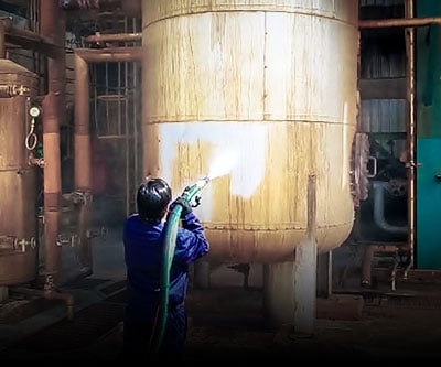 Dustless Blasting used to remove grime and old coatings off of a refinery liquid tank.